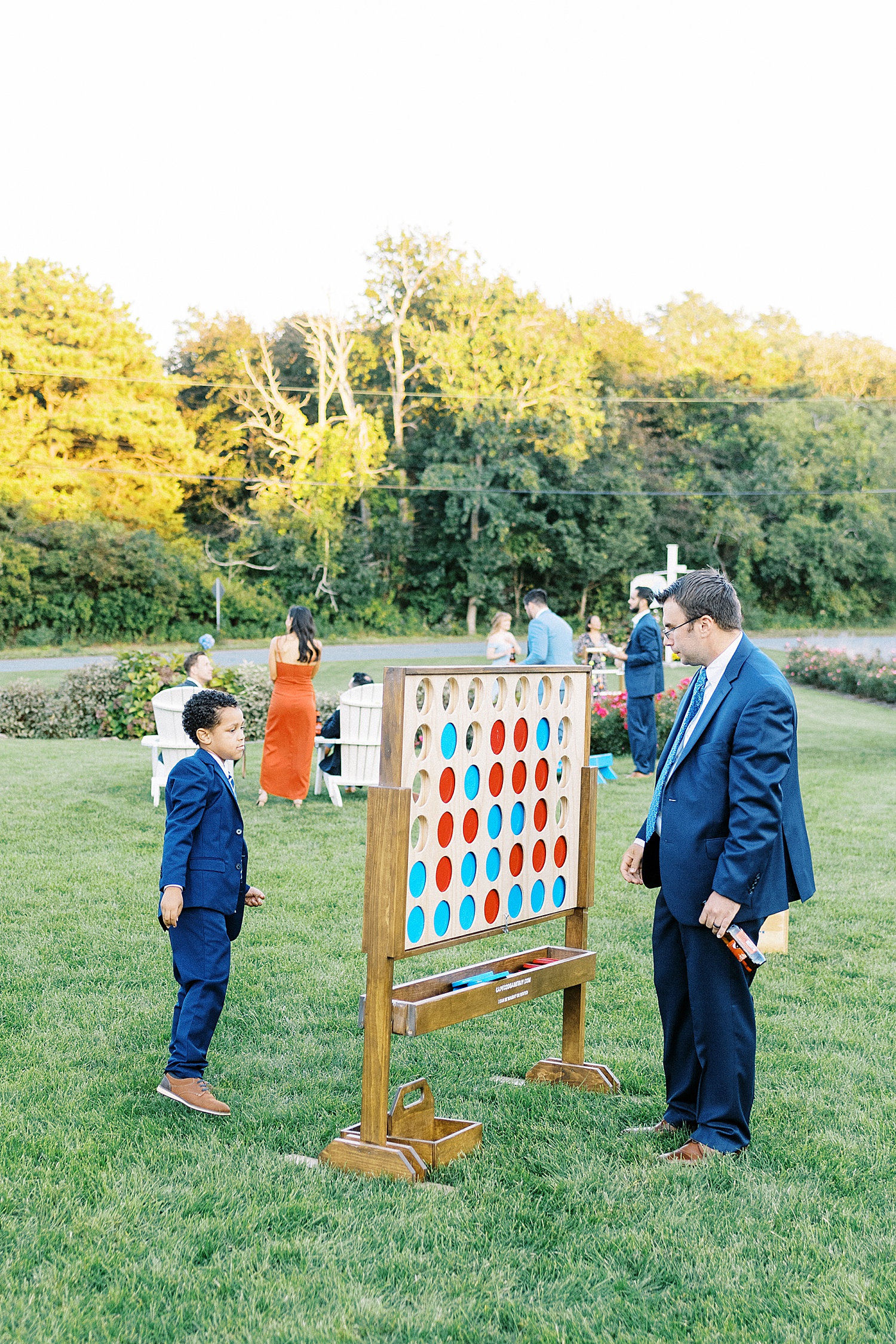 Guests playing giant connect 4 at Dennis Inn Wedding in Cape Cod