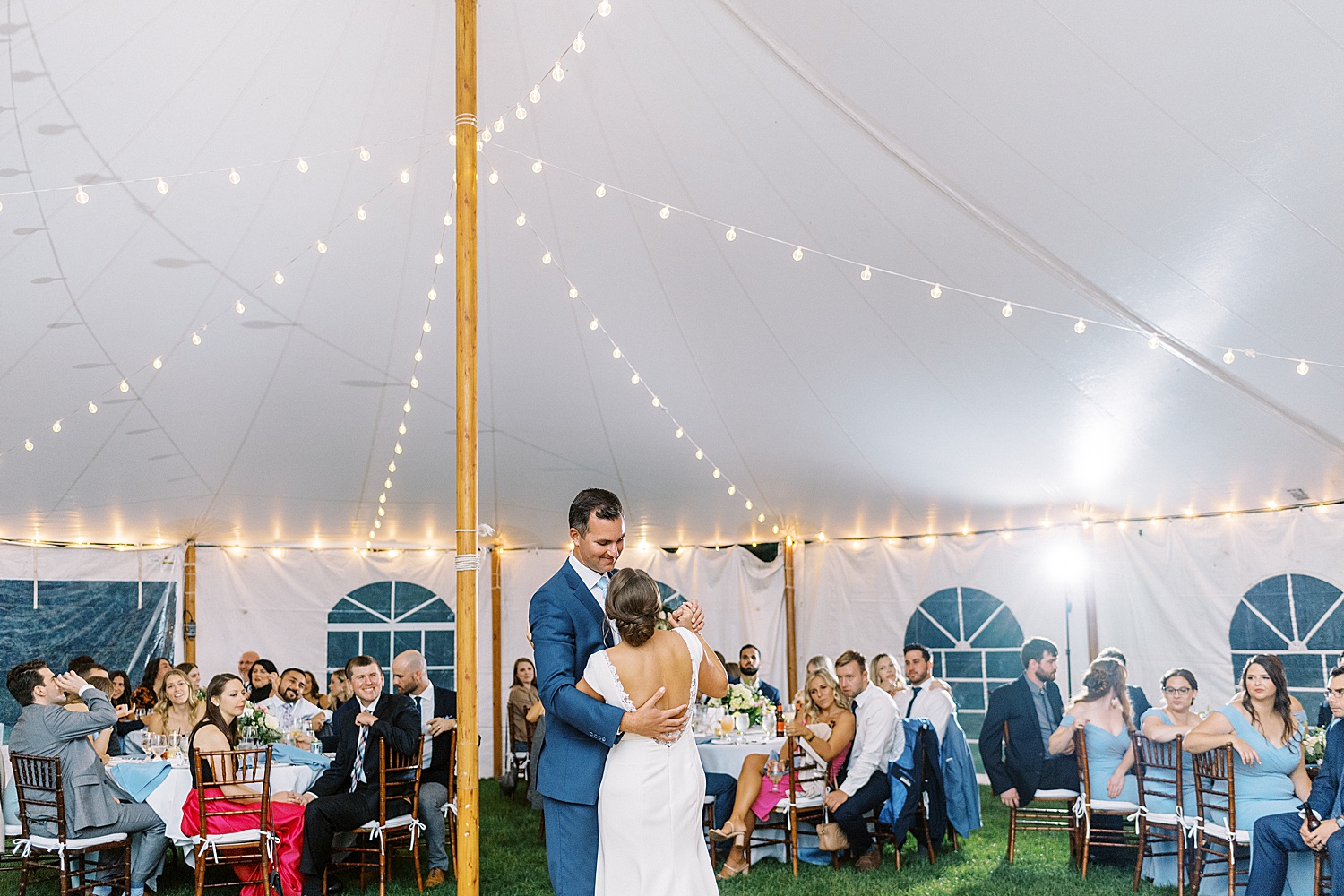 Newlyweds share a first dance under tent by Cape Cod wedding photographer Lynne Reznick