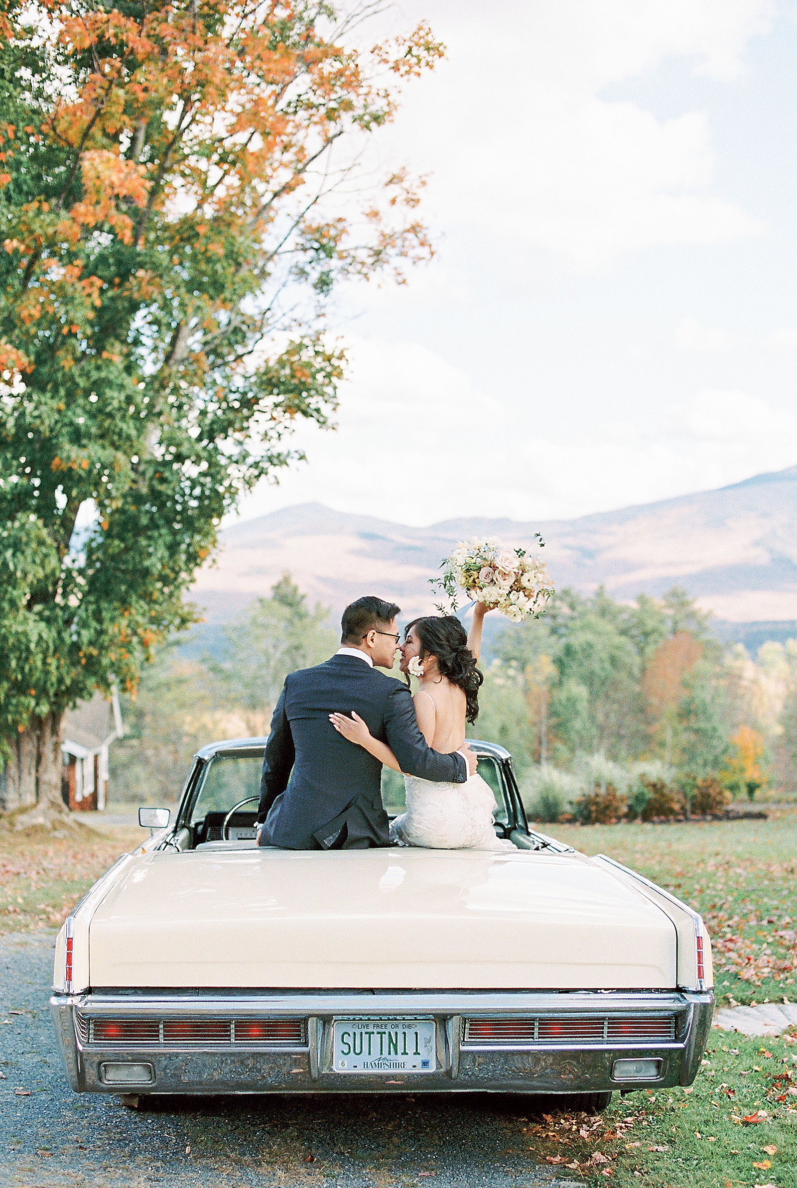 Wedding couple on a car by photographer who talks about The Impact of Client Experience on Your Marketing
