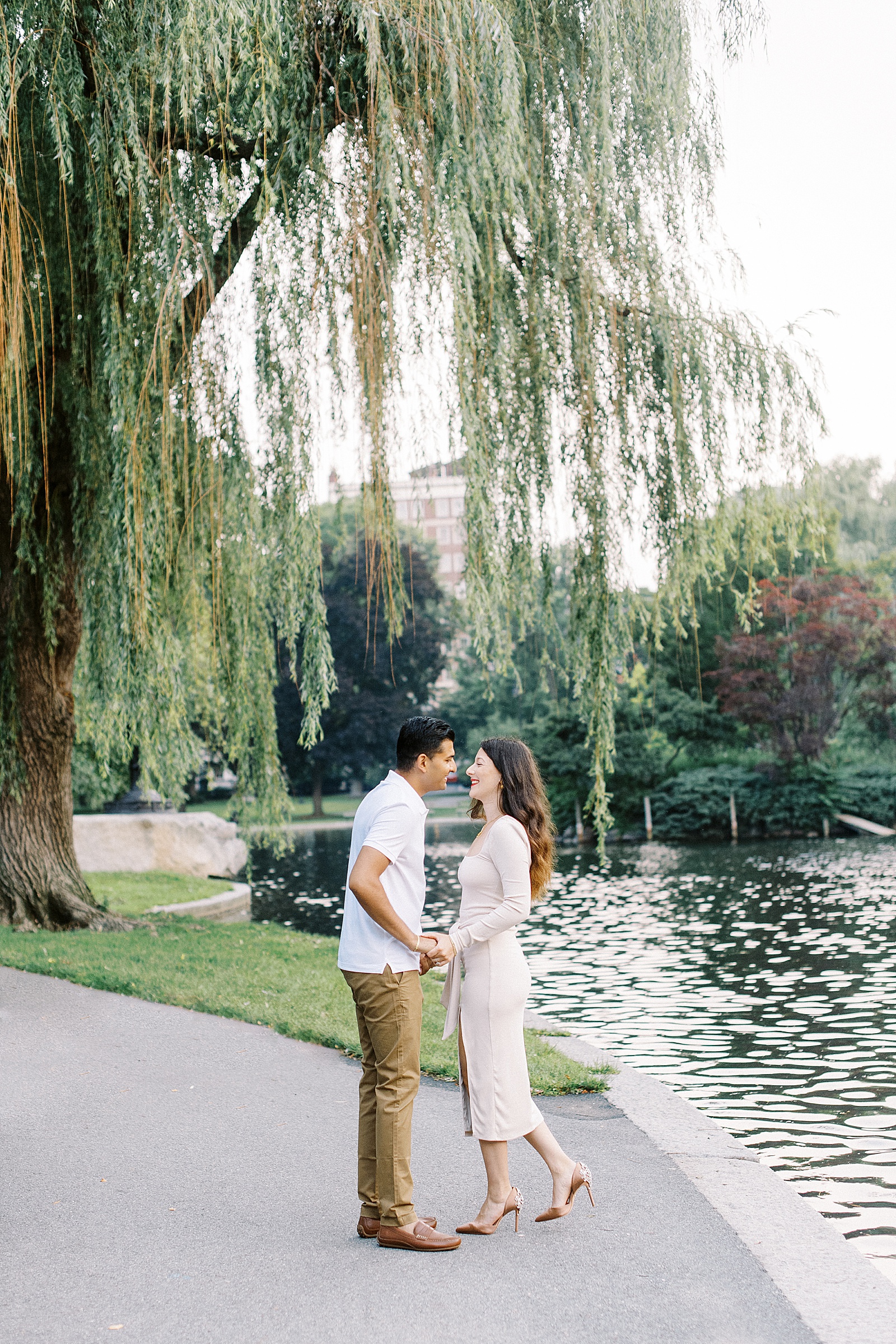 Brunette couple laughing together under willow tree by Lynne Reznick photography 