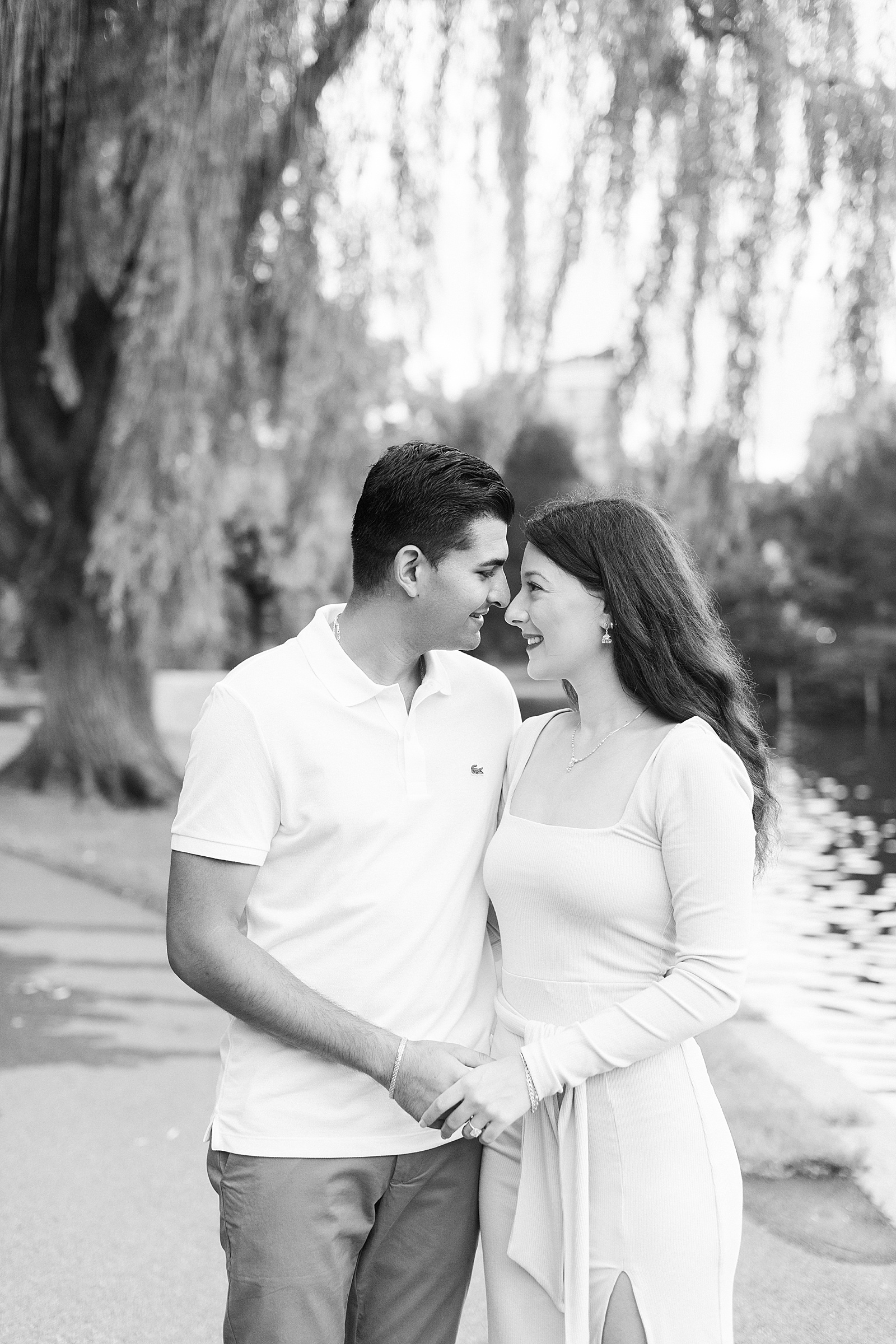 Couple about to kiss under a willow tree by Boston wedding photographer
