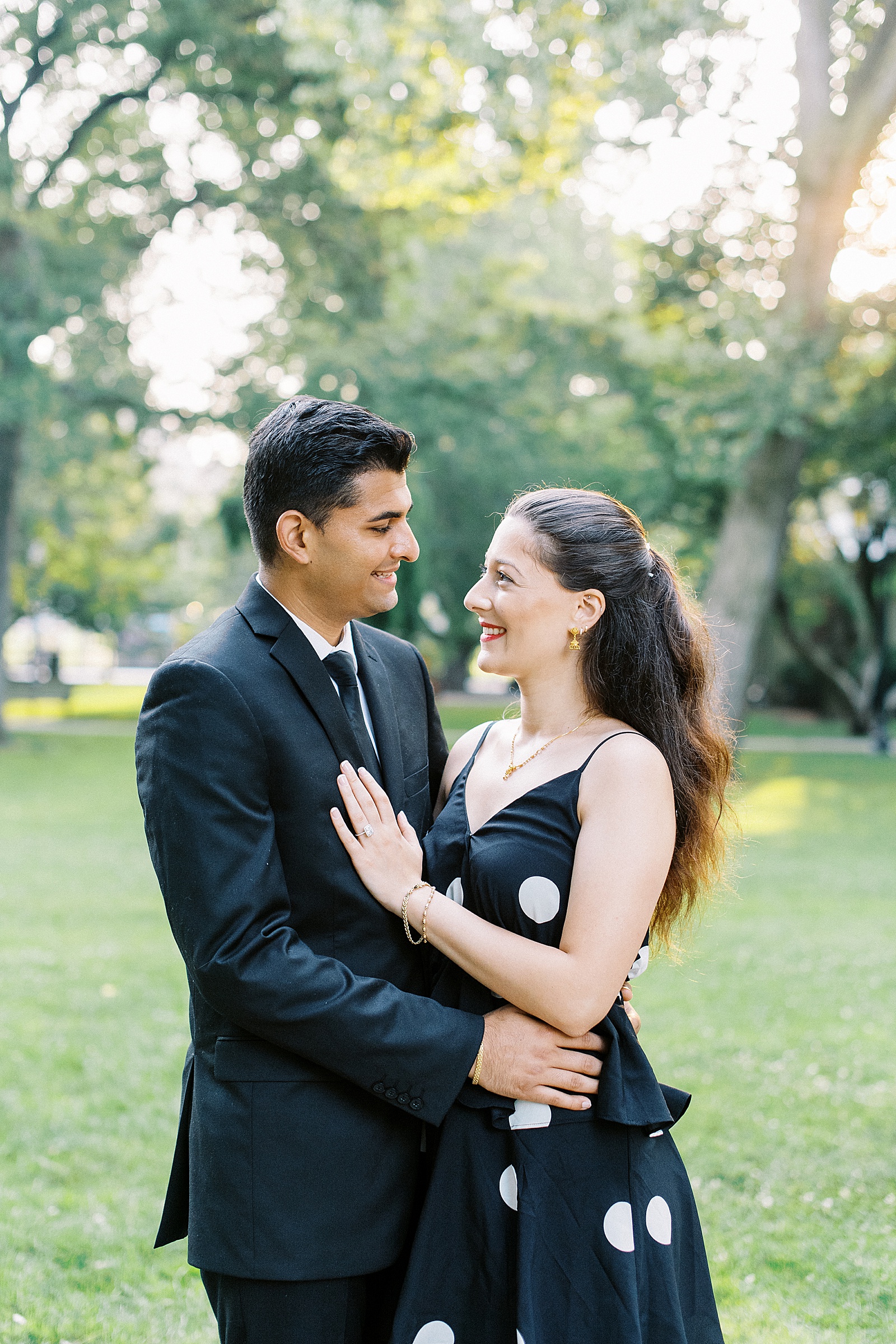Brunette couple embracing in a field by Boston wedding photographer