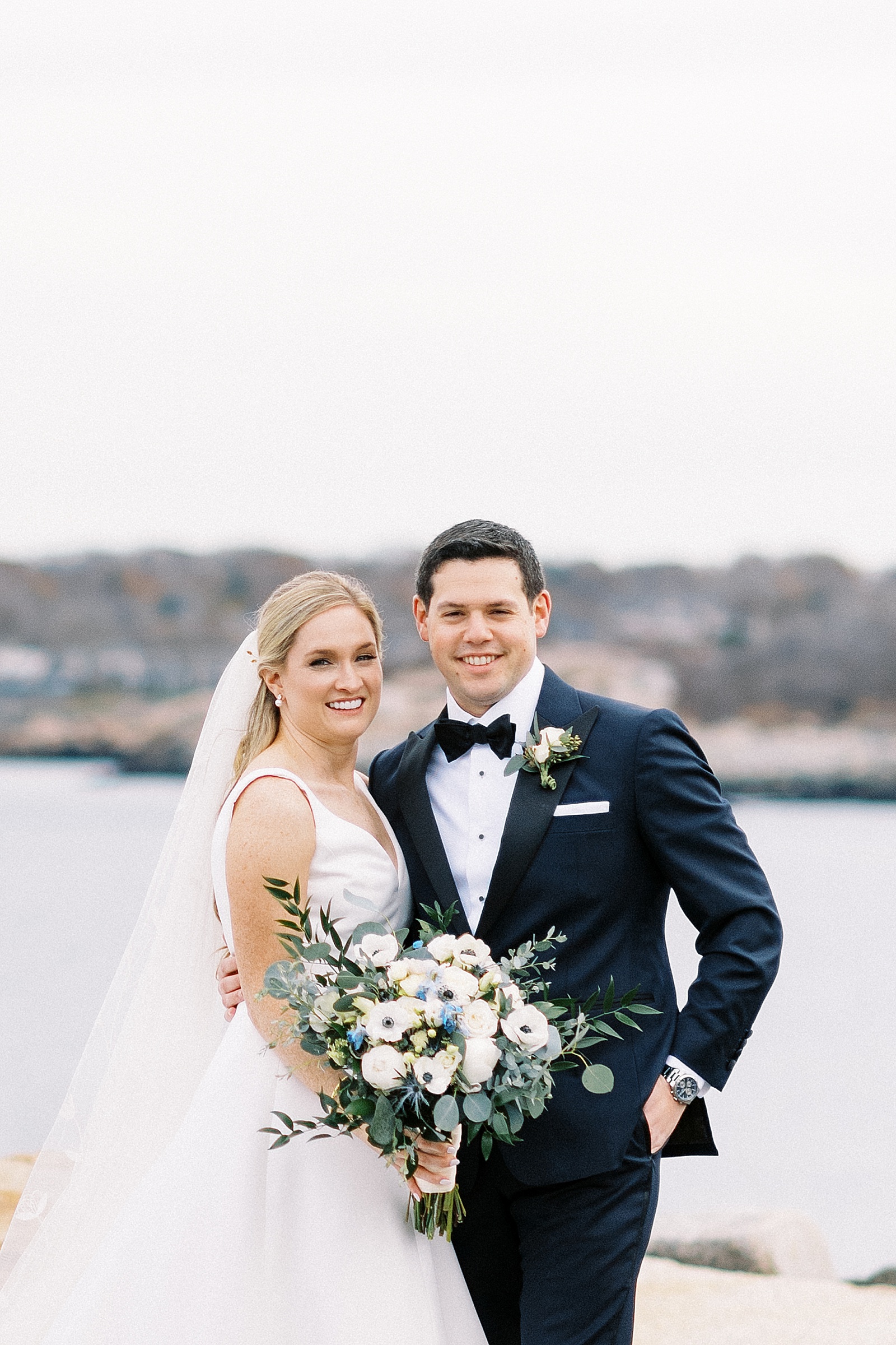 bride and groom by the water from photographer who cultivates client comfort