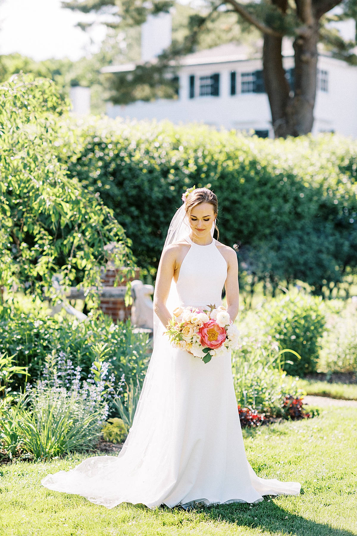 bride with simple, modern gown holds bouquet with shite and hot pink flowers | Lynne Reznick Photography