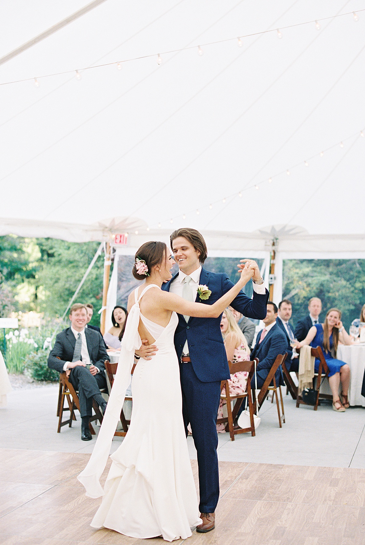 bride and groom share first dance in elegant garden tent reception shot by Massachusetts wedding photographer