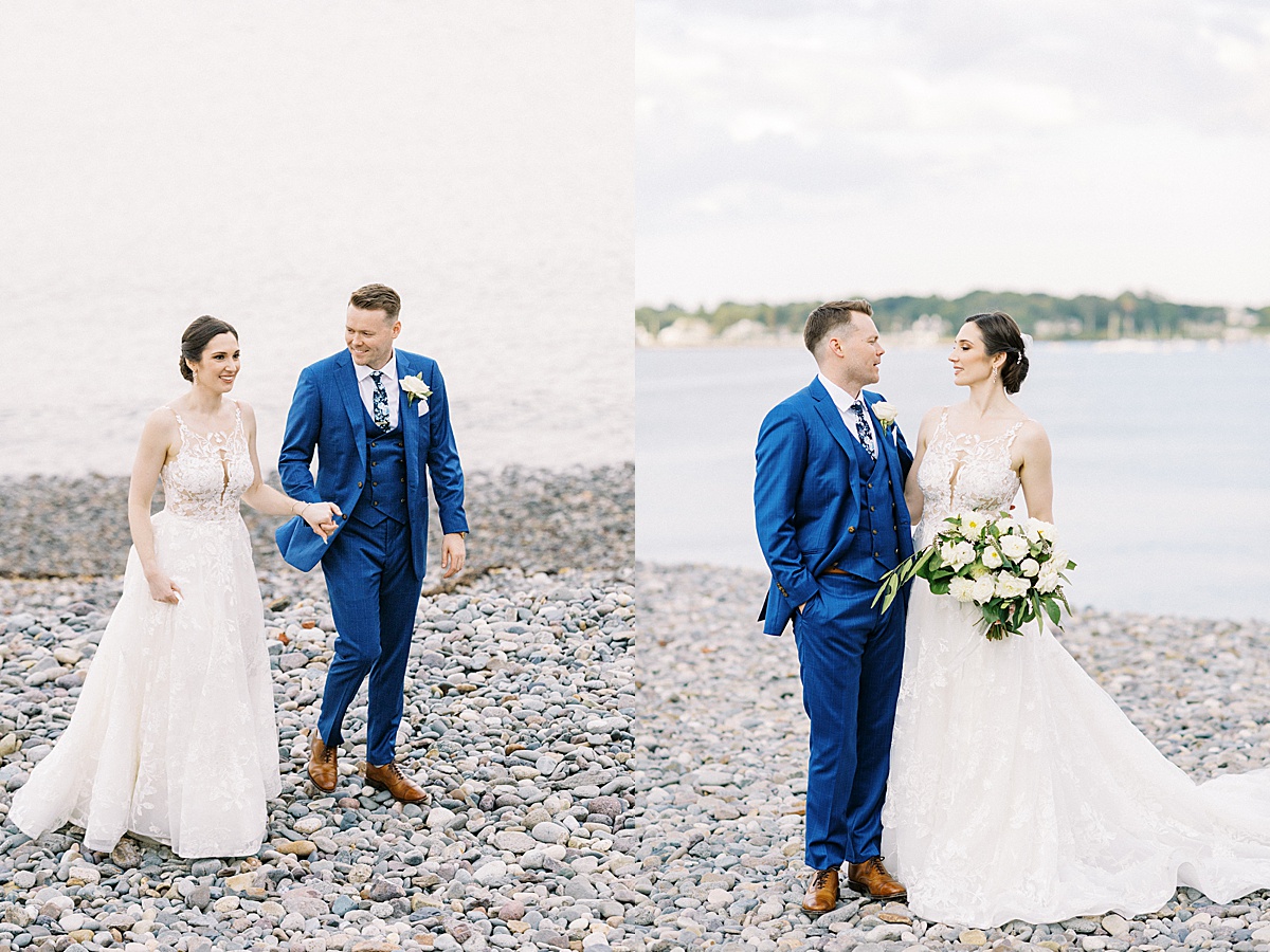 bride in elegant gown and groom in preppy blue suit pose by the water for Massachusetts wedding photographer