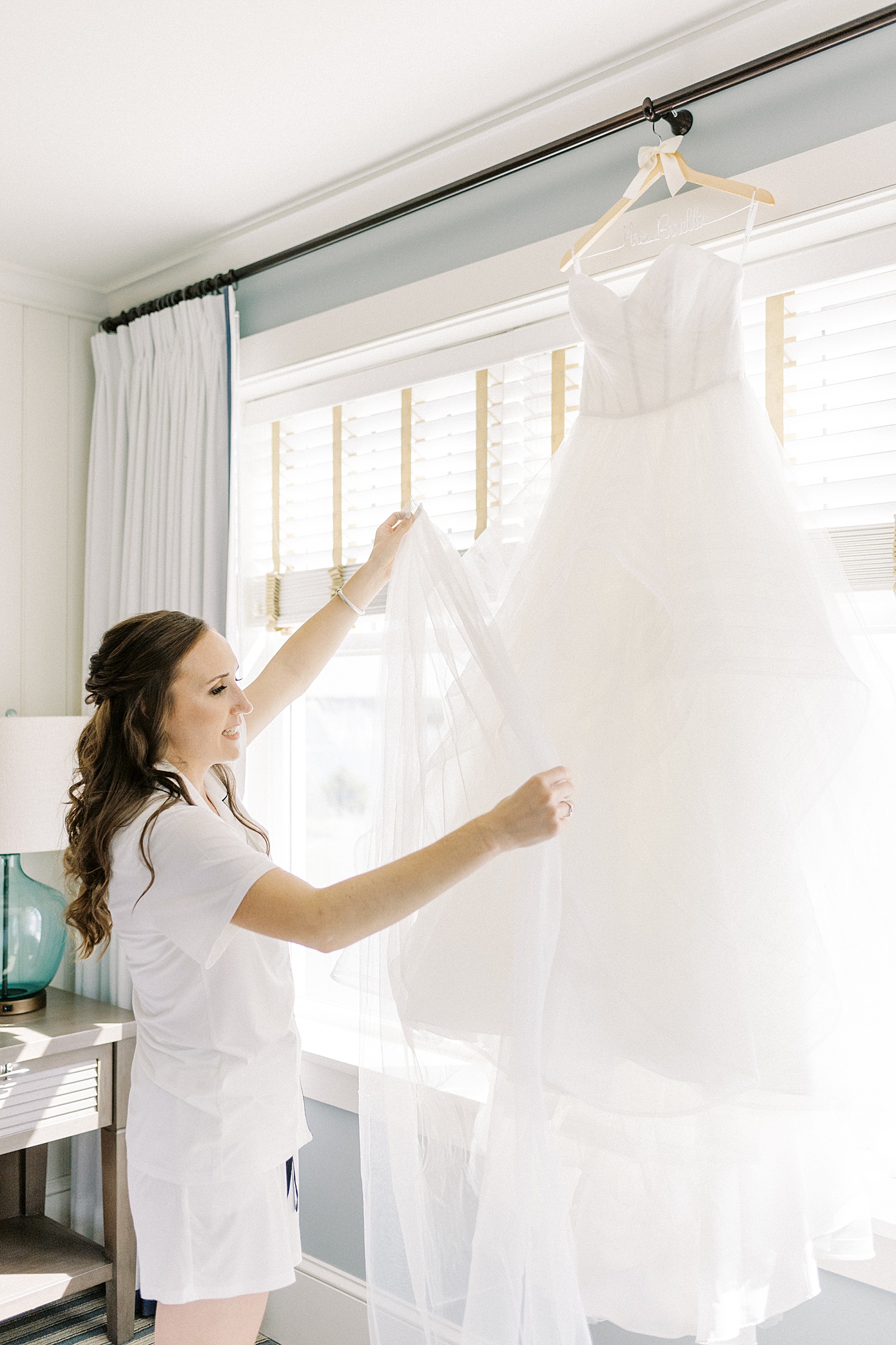 bride examines her dress before ceremony at Beauport Hotel