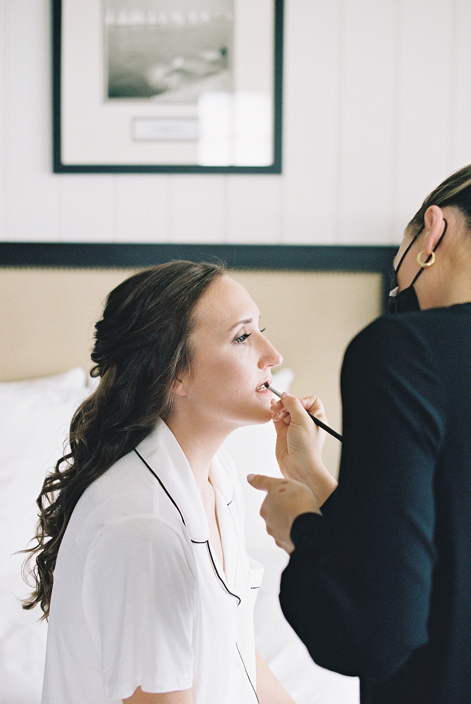 Woman getting makeup done before her ceremony by Lynne Reznick photography