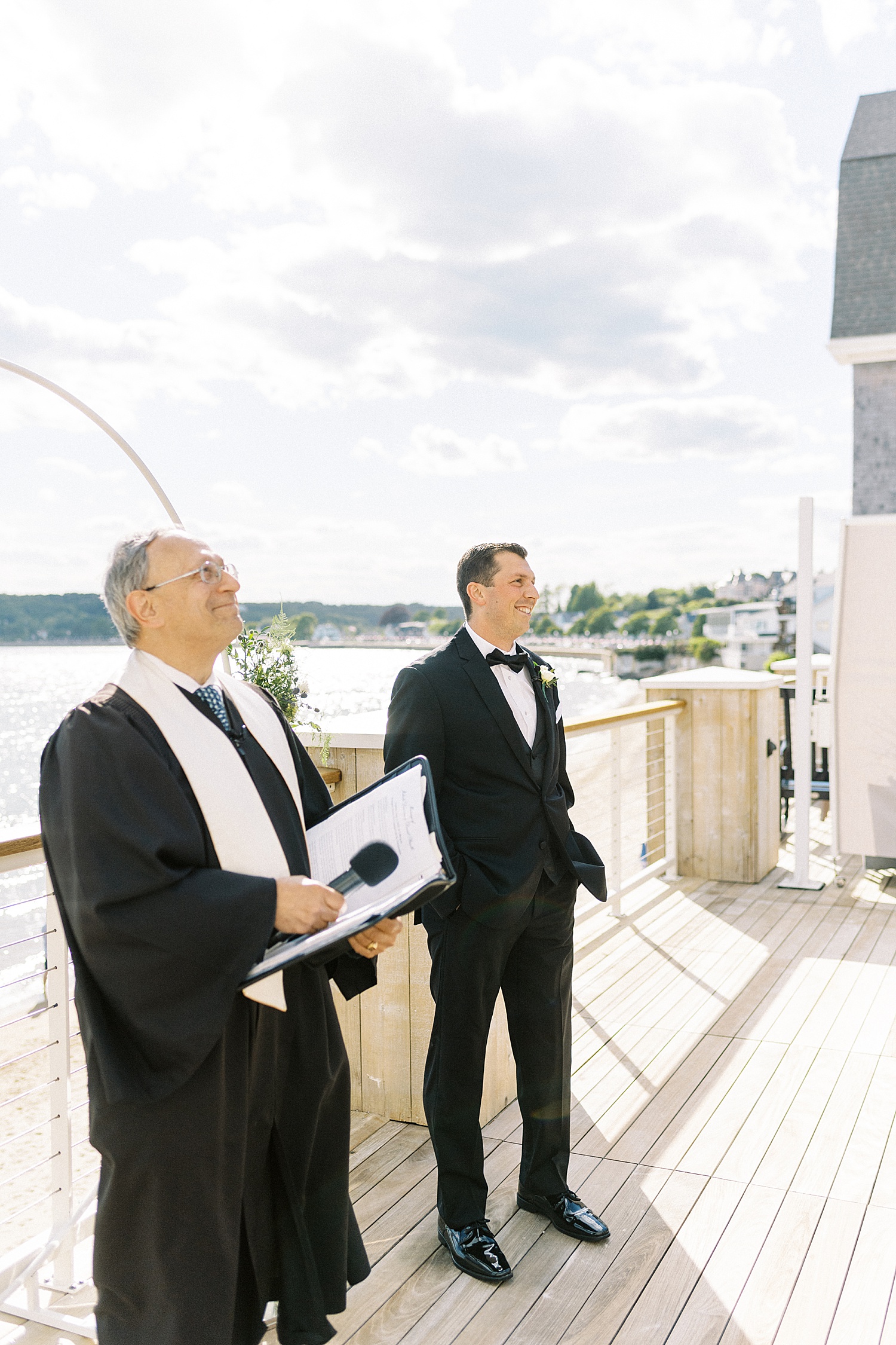 Groom watching his bride walk down the aisle by Lynne Reznick photography