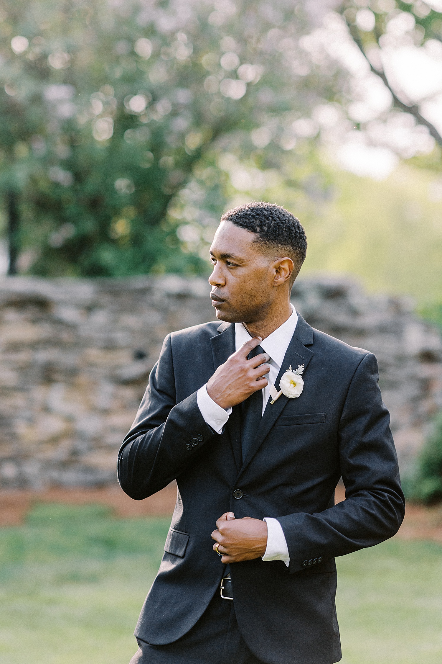 Groom in black suit outdoors by New York Photographer