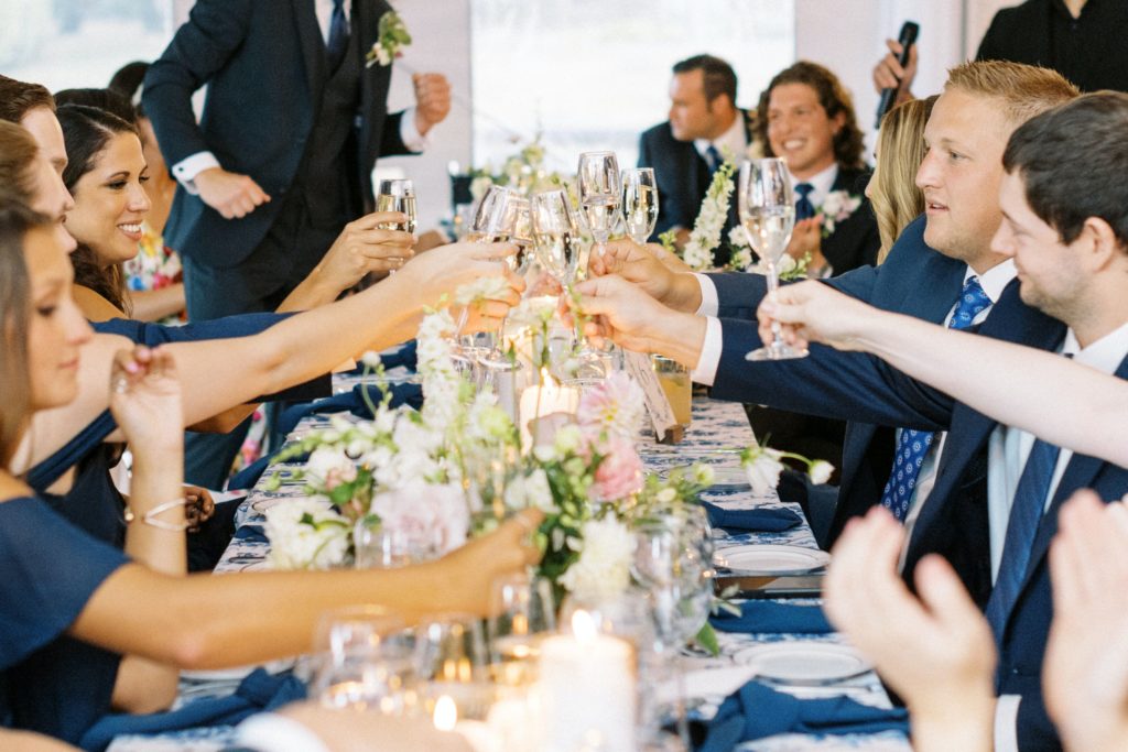 wedding guests clinking glasses after a great wedding toast