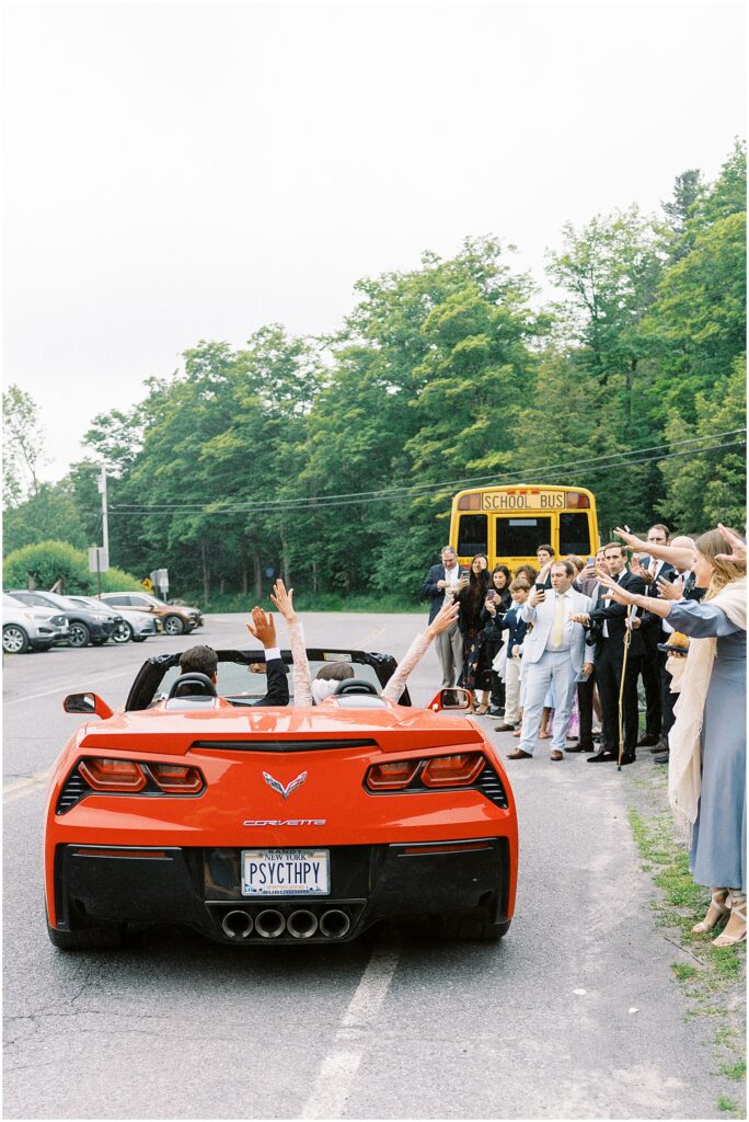 newlyweds drive off in red corvette after Catskills wedding ceremony