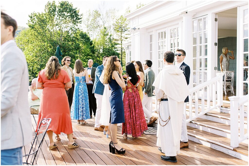 guests mingle during al fresco cocktail hour at wedding welcome party in the Catskills