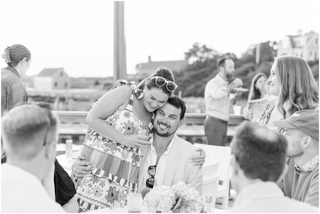 black and white of bride and groom enjoying welcome party