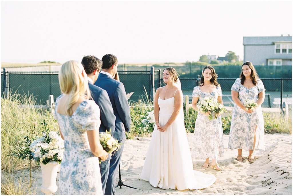 bride and groom exchange vows in sunny beachside wedding ceremony in Chatham MA