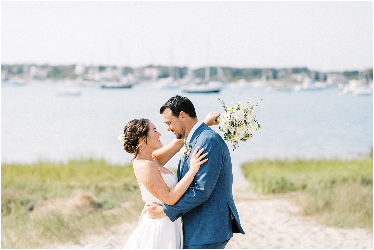 sunny bride and groom beach portrait in Chatham on Cape Cod