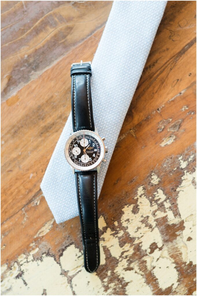 grooms tie and watch styled in a flat lay