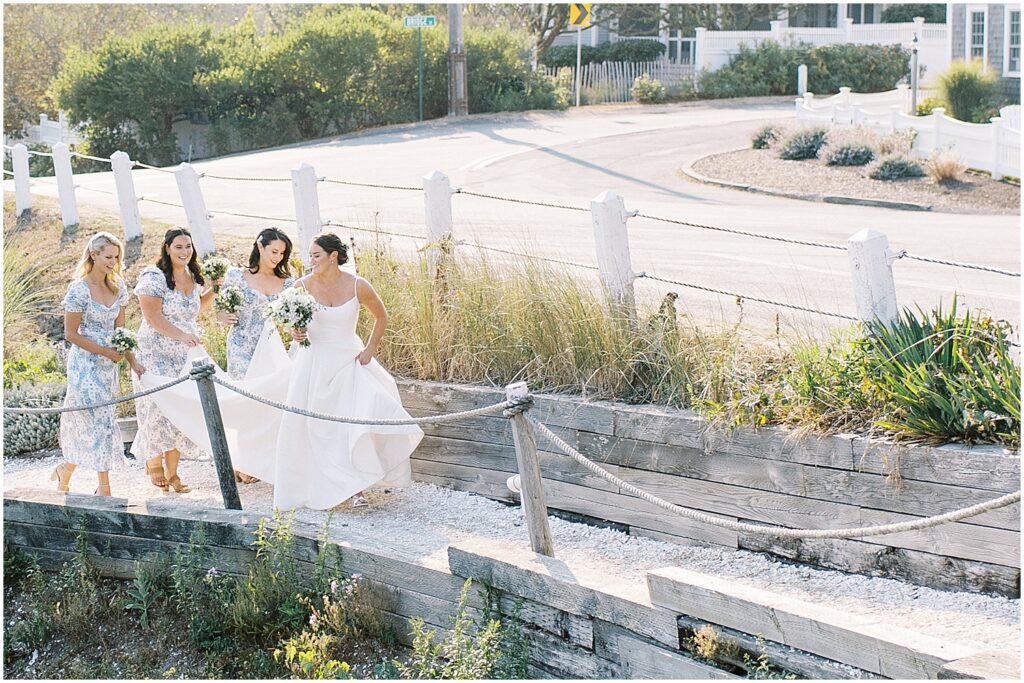 bride and bridesmaids walking into wedding venue