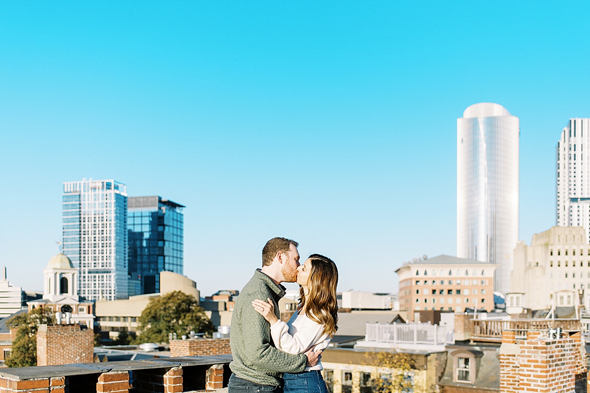 Couple kissing in the city in front of a Boston Wedding Photographer