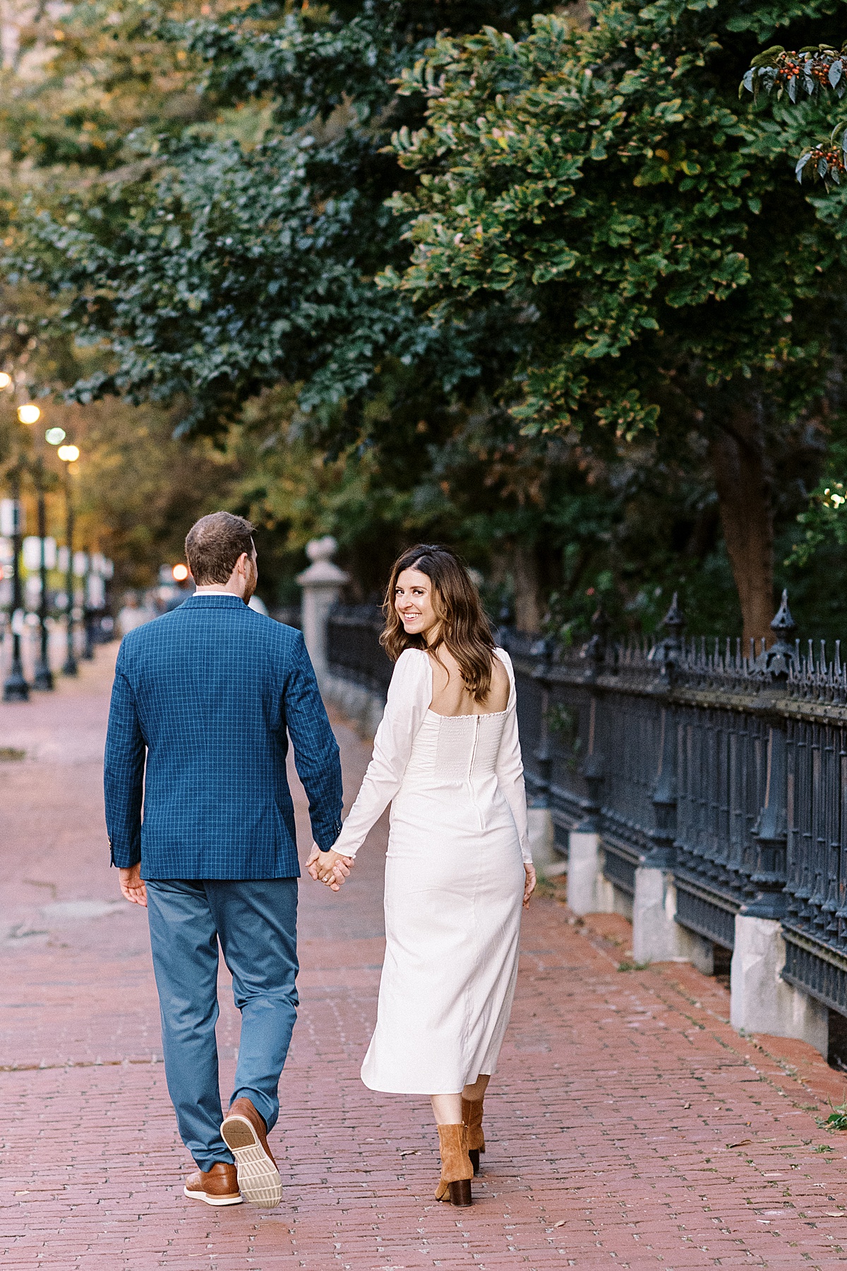 couple walking down their street for their engagement photos taken by Lynne Reznick Photography