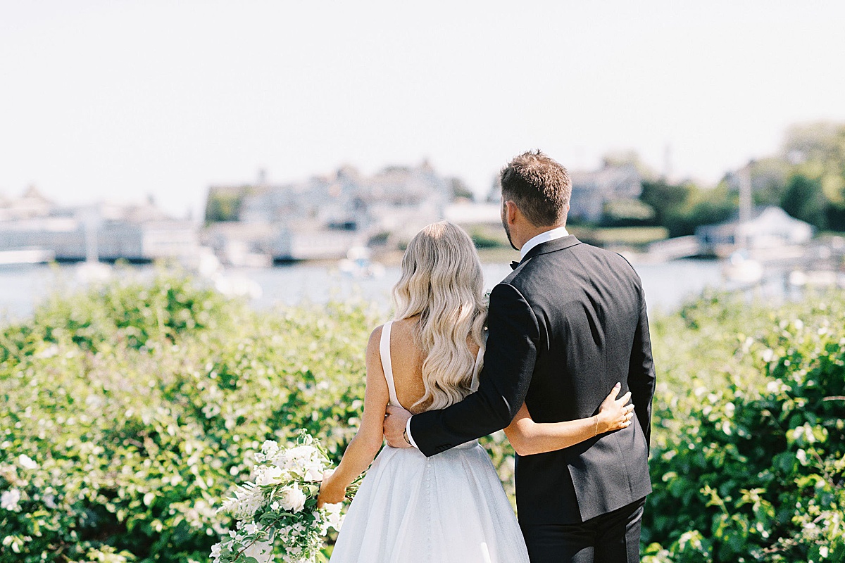 bride and groom looking out to the water captured by Cape Cod Wedding Photographer