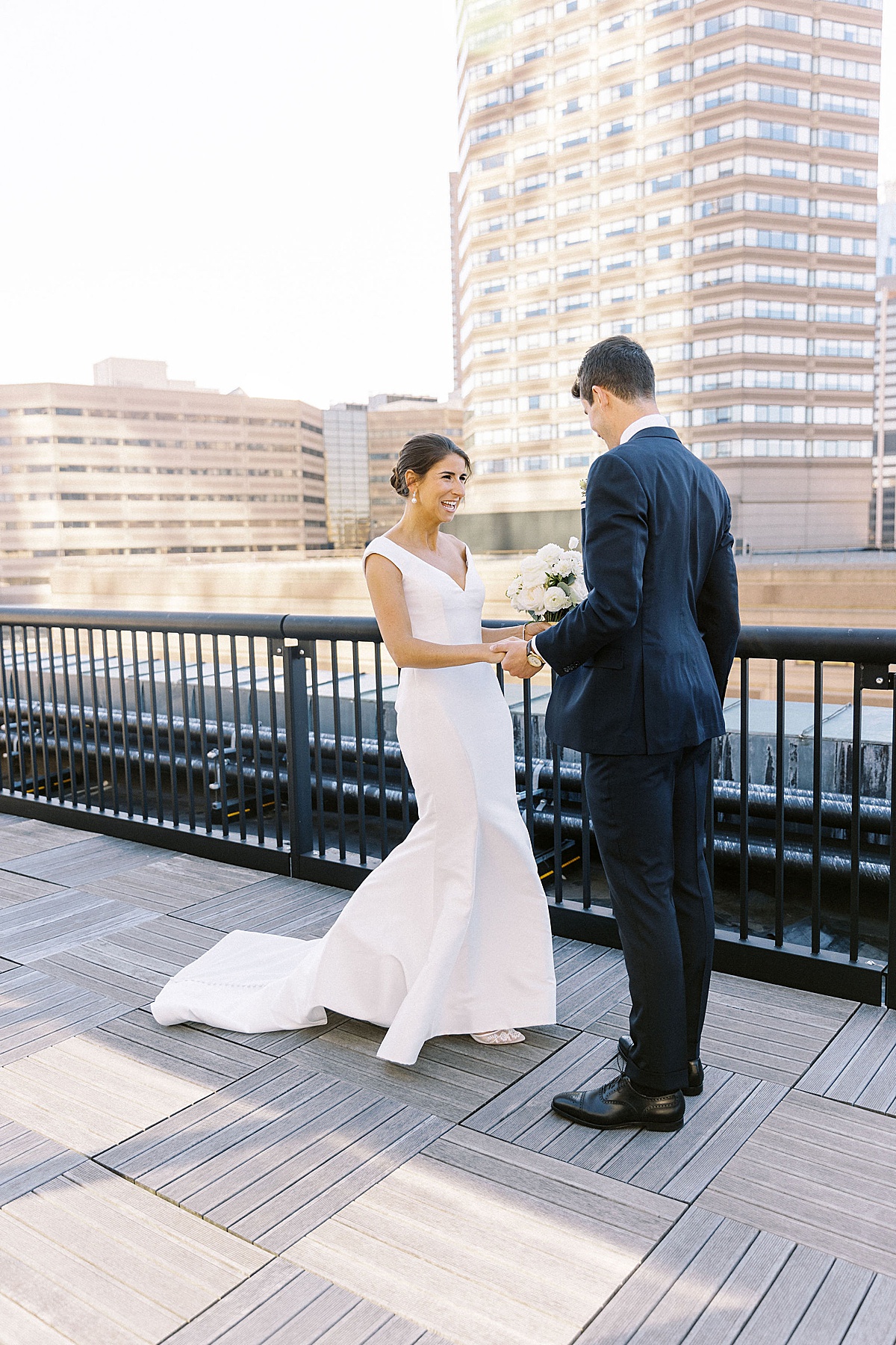 woman holding mans hand while smiling captured by Boston Wedding Photographer