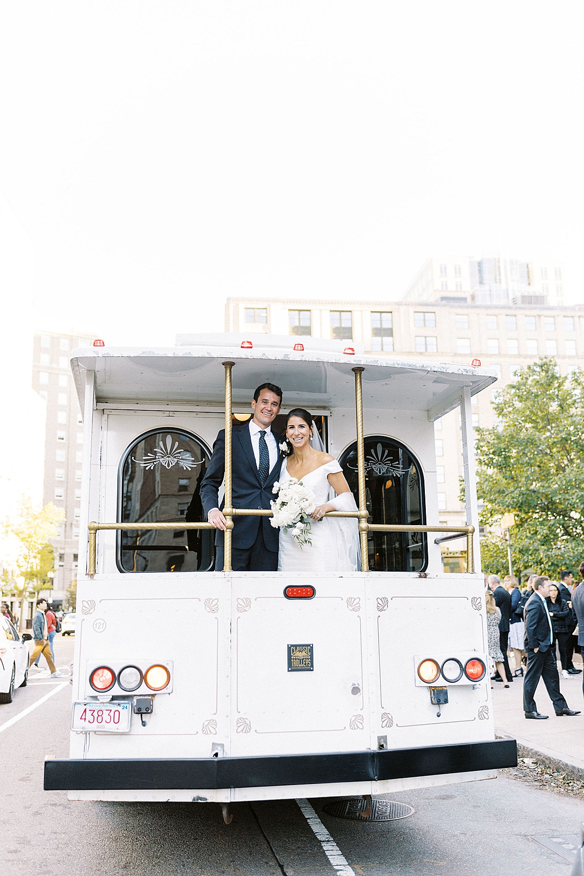 bride and groom ride trolly in the city of Boston Captured by Lynne Reznick Photography 