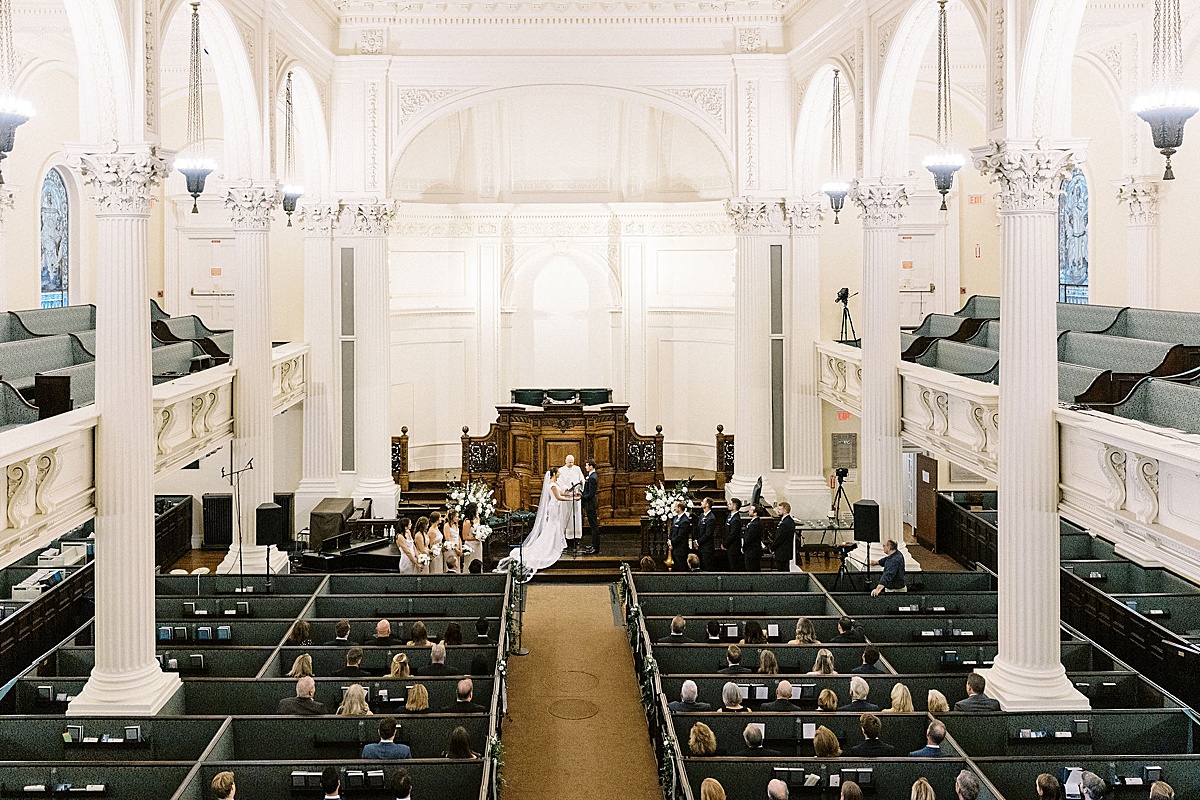 bride and groom getting married inside a church captured by Boston wedding photographer