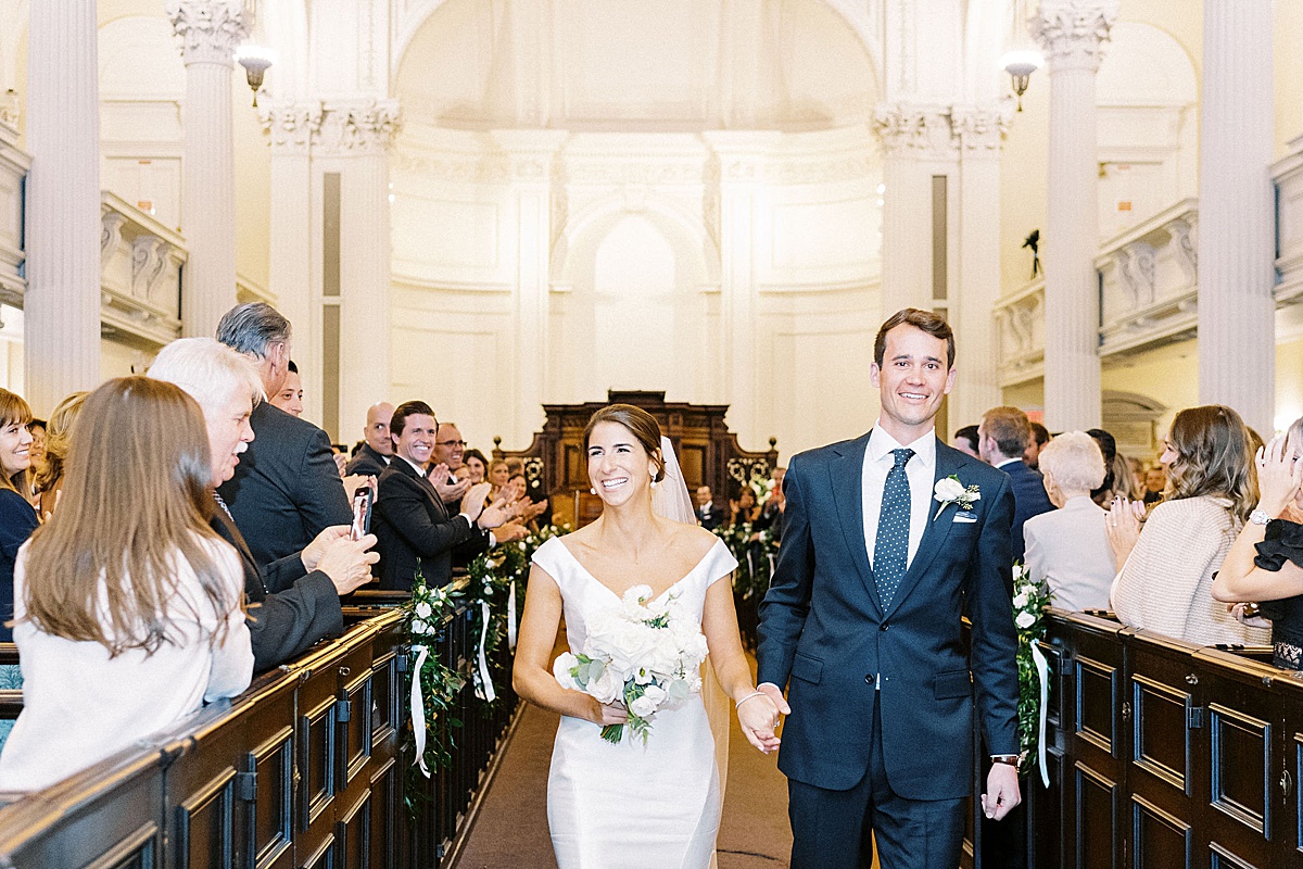 man and women smiling and exiting church captured by Lynne Reznick Photography 