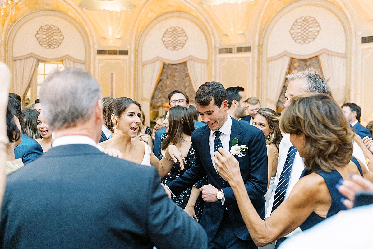 bride and groom dancing with family at Fairmont Copley 
