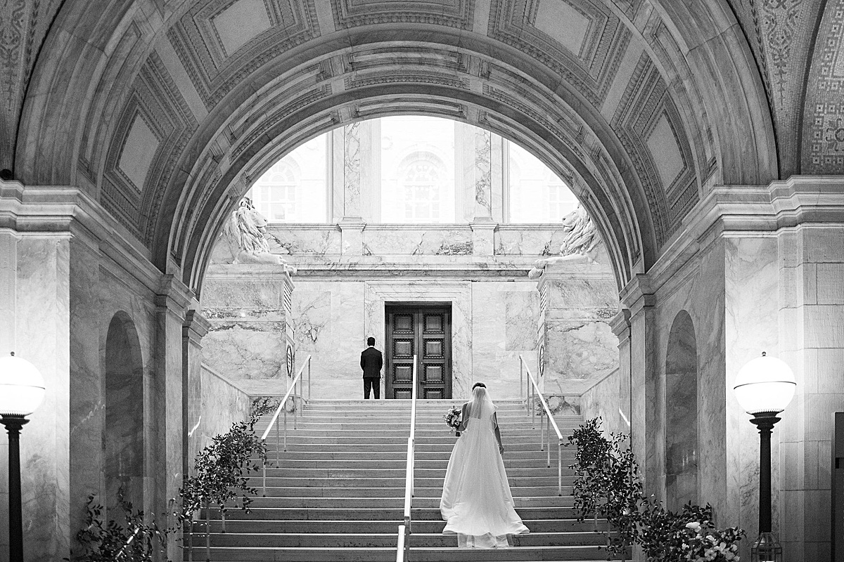 bride and groom on steps of The  Public Library for their wedding