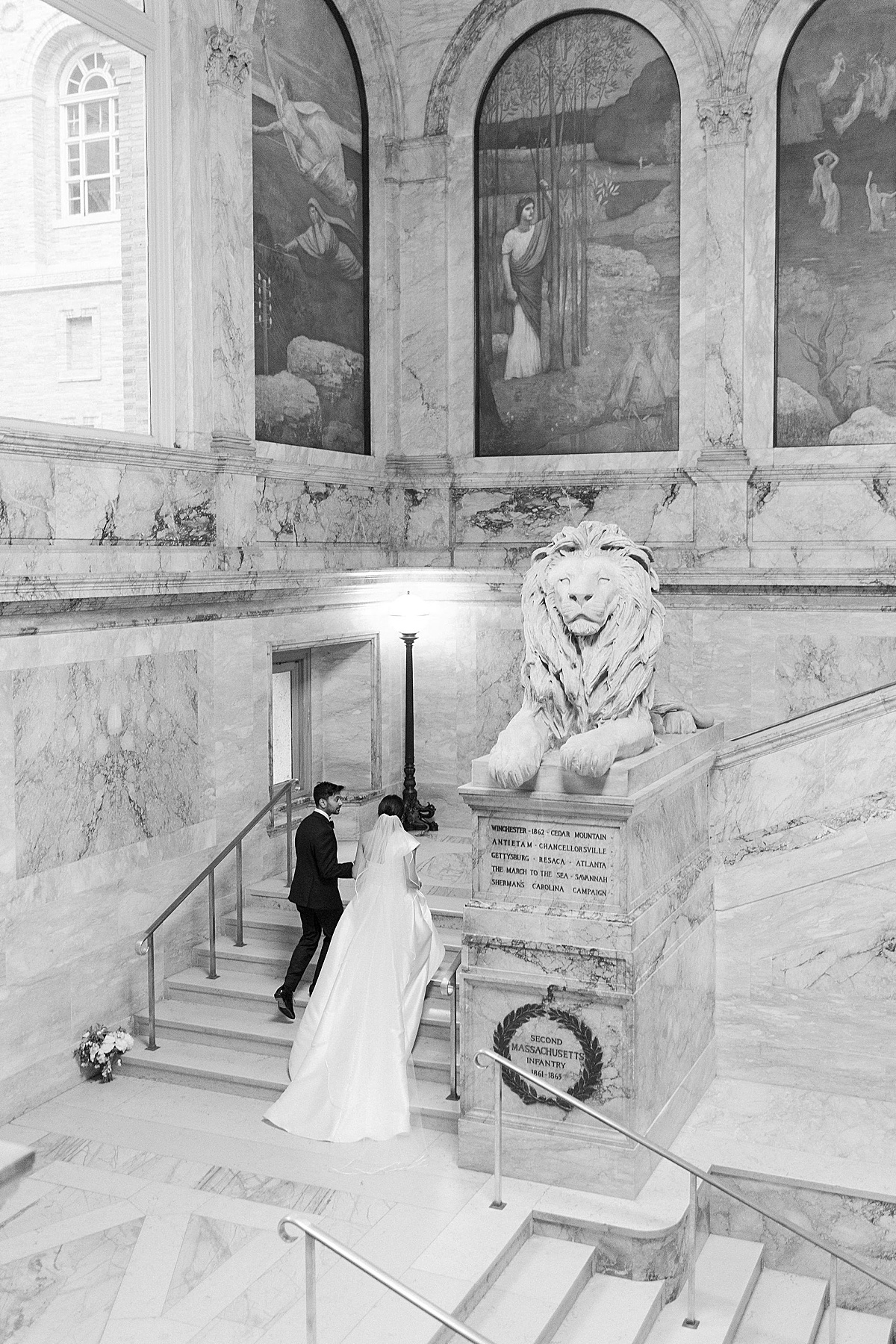 bride and groom walking up steps holding hands captured by boston wedding photographer