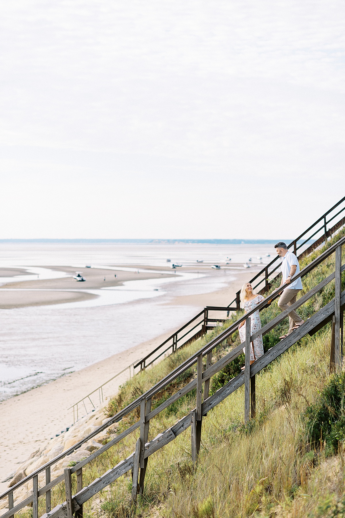 man and women walking down steps during Cape Cod Engagement
