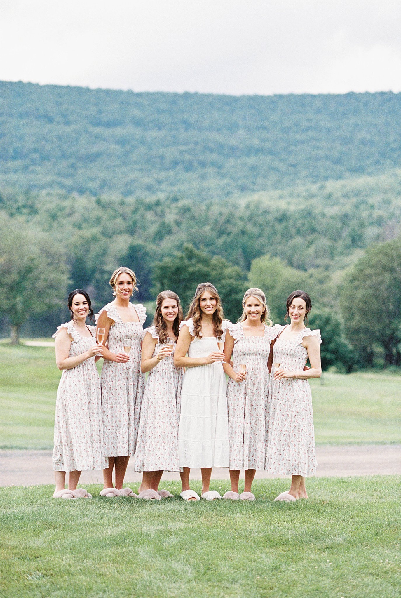 bridal party gathers for champagne toast on grounds at Onteora Club