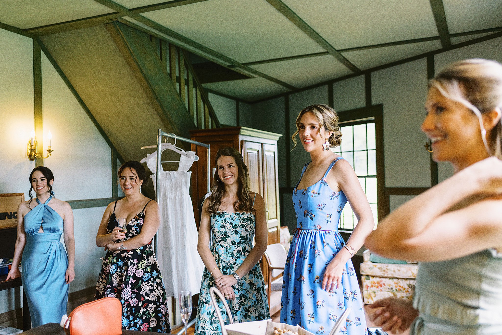 bridal party watches as bride reveals look by Cape Cod wedding photographer