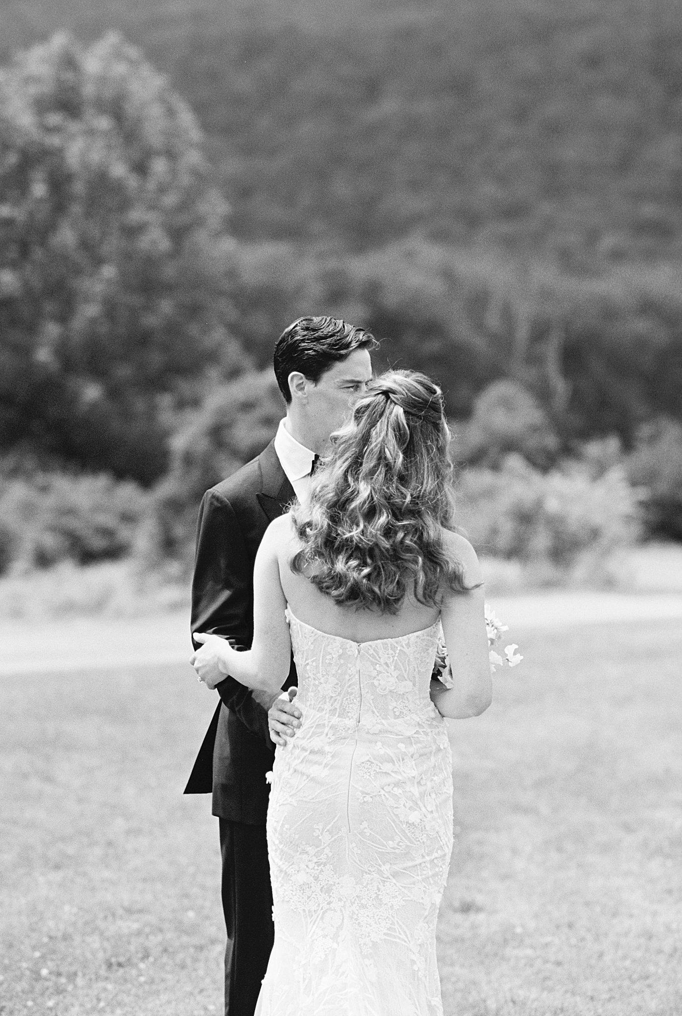 couple faces each other as they talk by Catskills wedding photographer