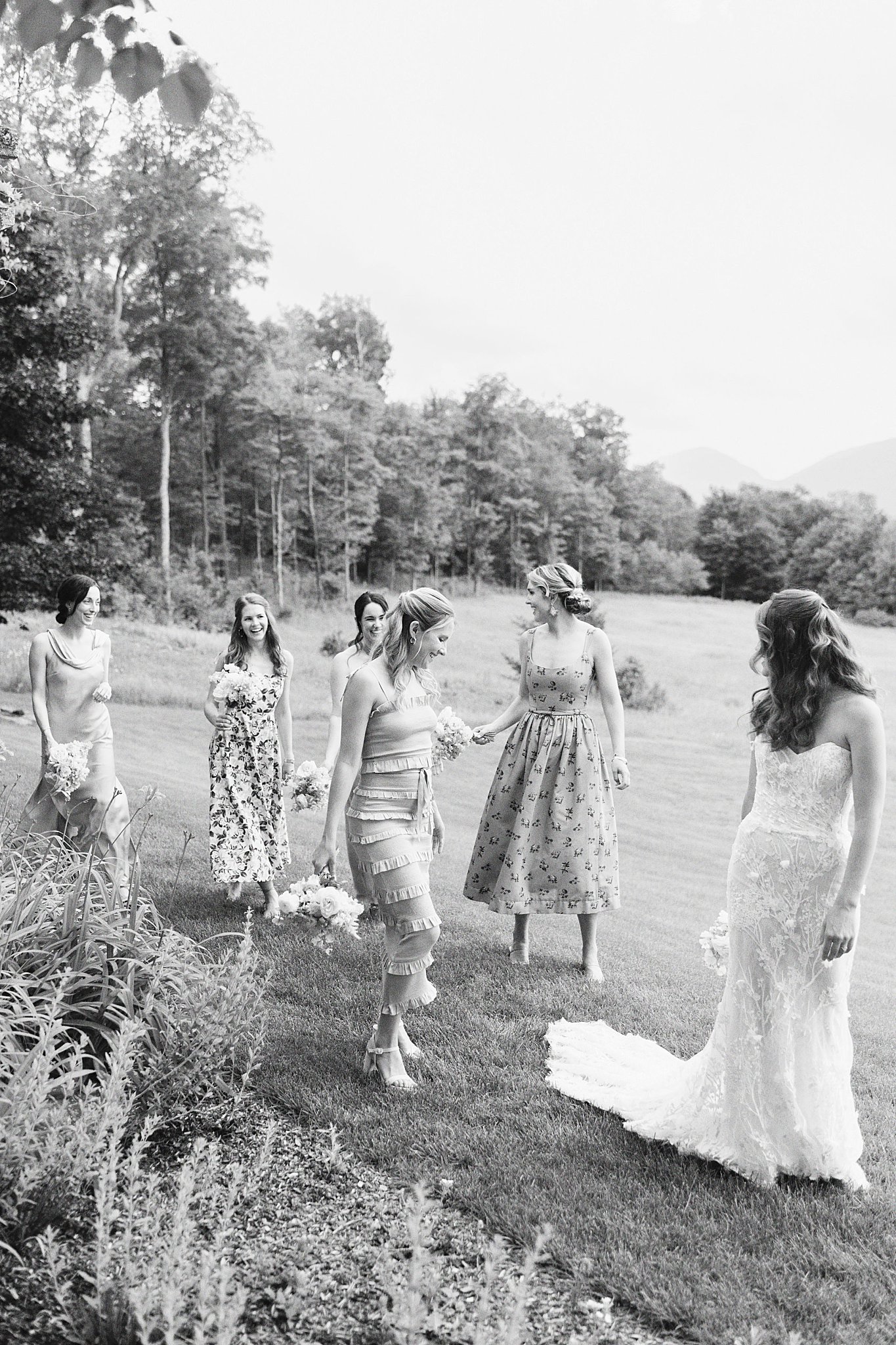 bridal party walks together behind bride by Lynne Reznick Photography 
