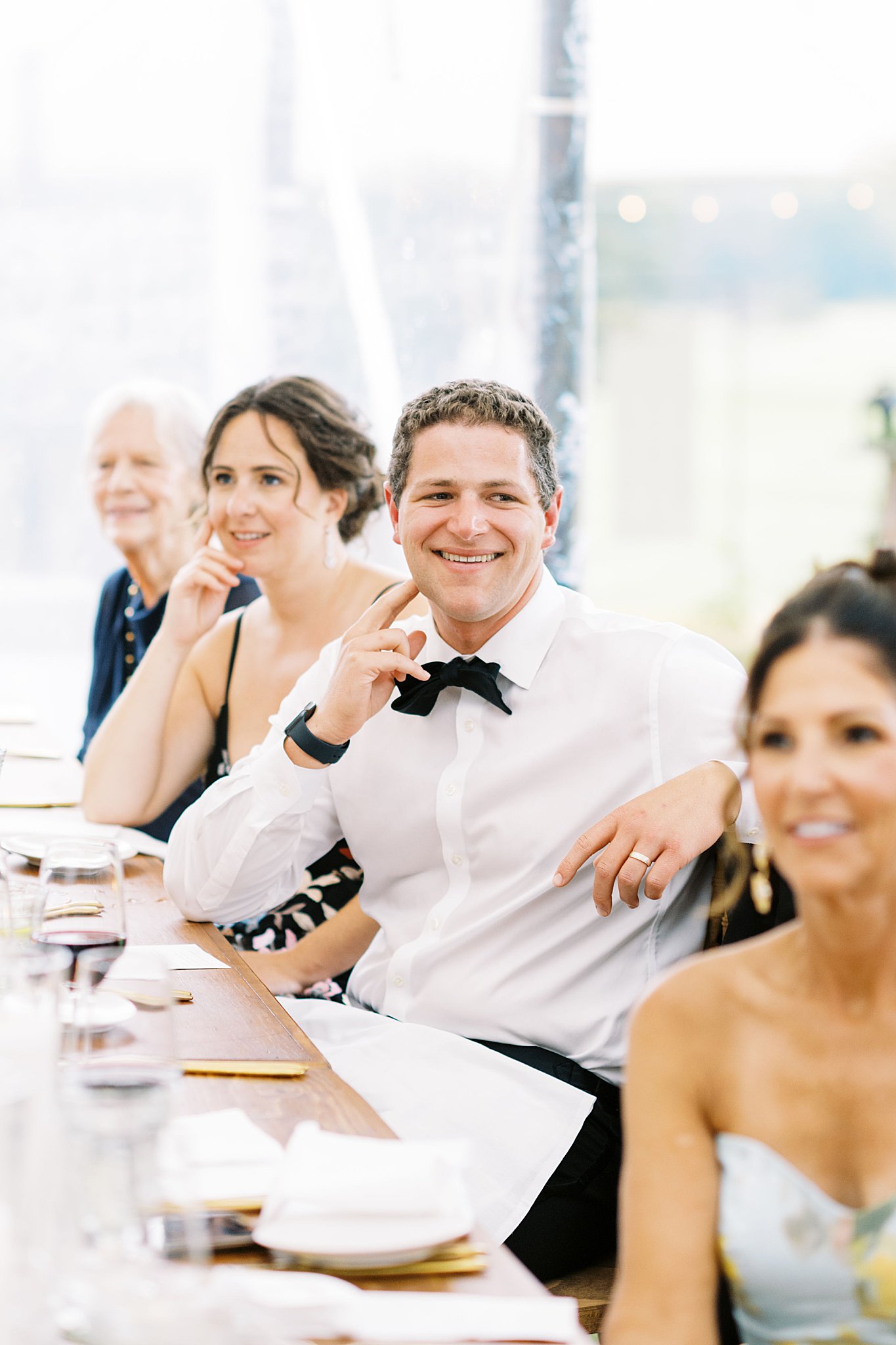 guest listen to toasts during reception by Cape Cod wedding photographer