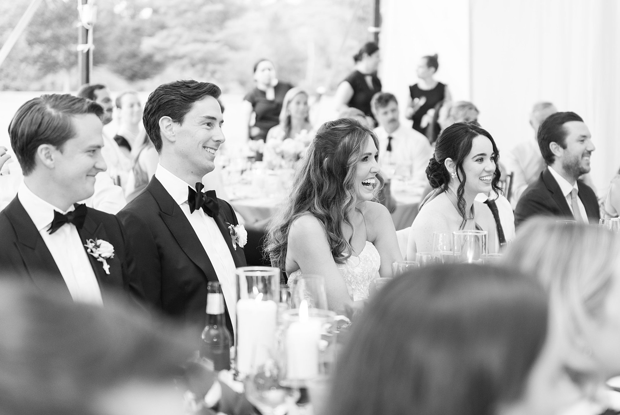 couple laughs as they are toasted at reception by Lynne Reznick Photography 