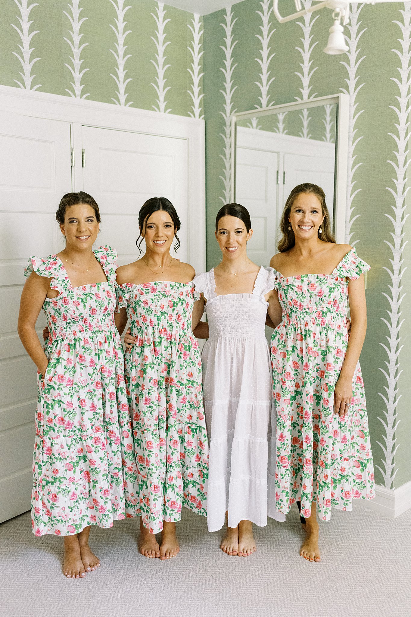bridesmaids in matching dresses stand with arms around bride at Field Club of Greenwich 