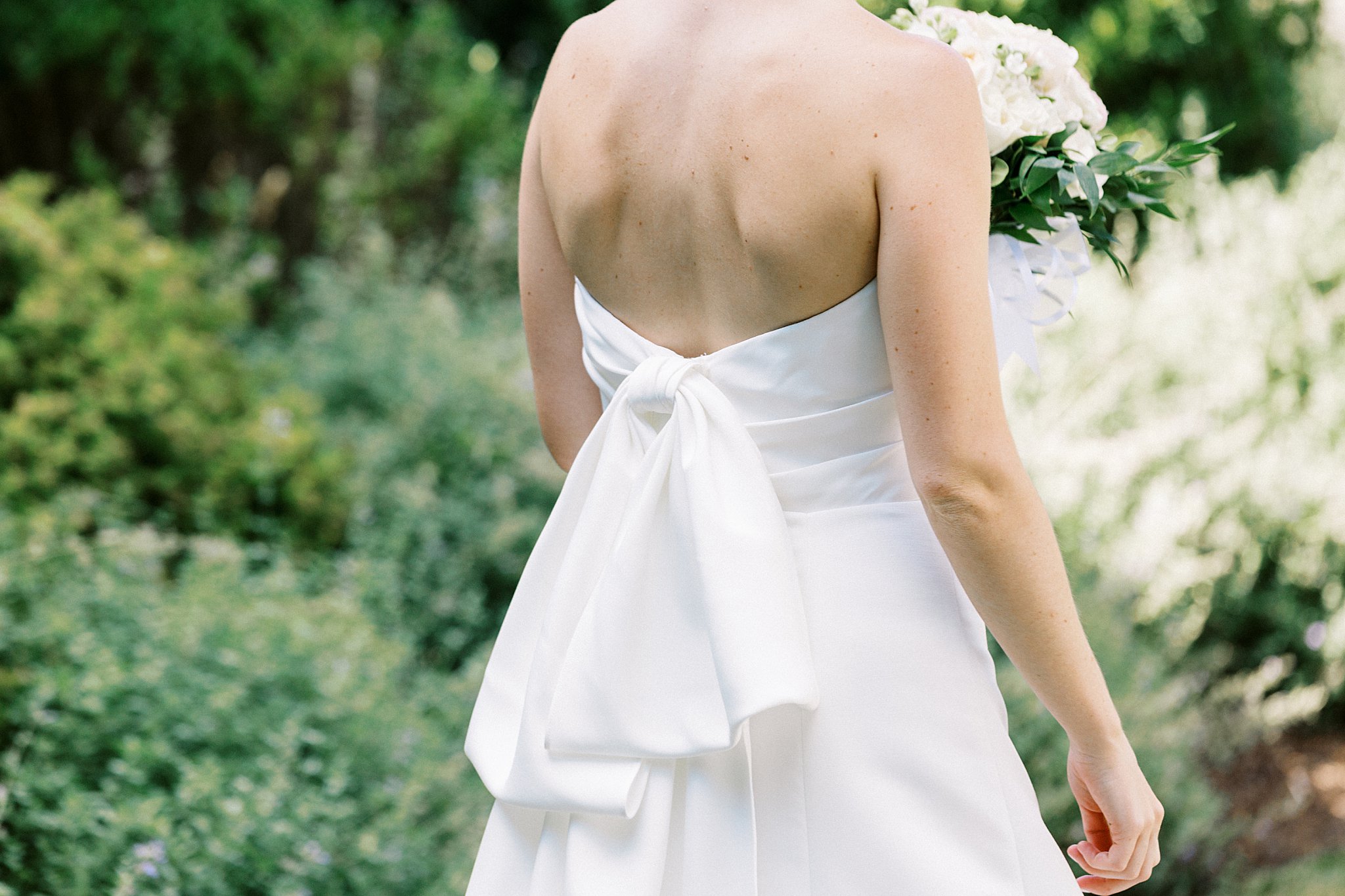 back of dress has dramatic bow by Lynne Reznick Photography 