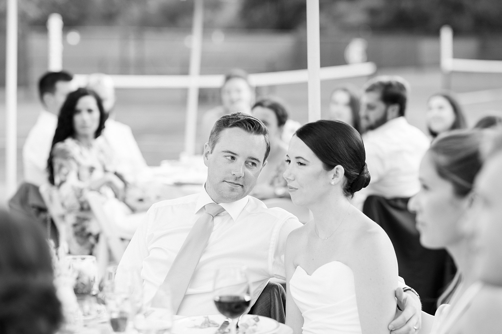 man looks at his wife by Cape Cod wedding photographer
