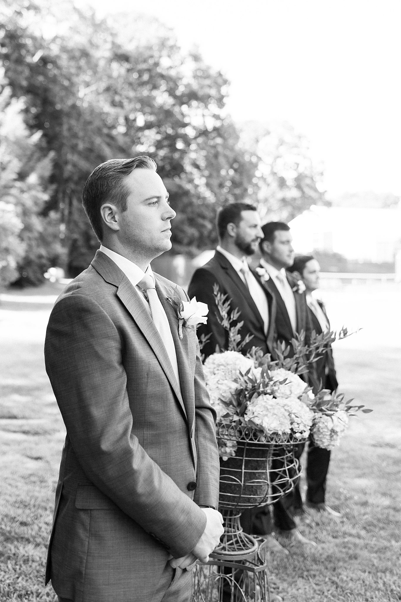 man and groomsmen look down the aisle by Cape Cod wedding photographer