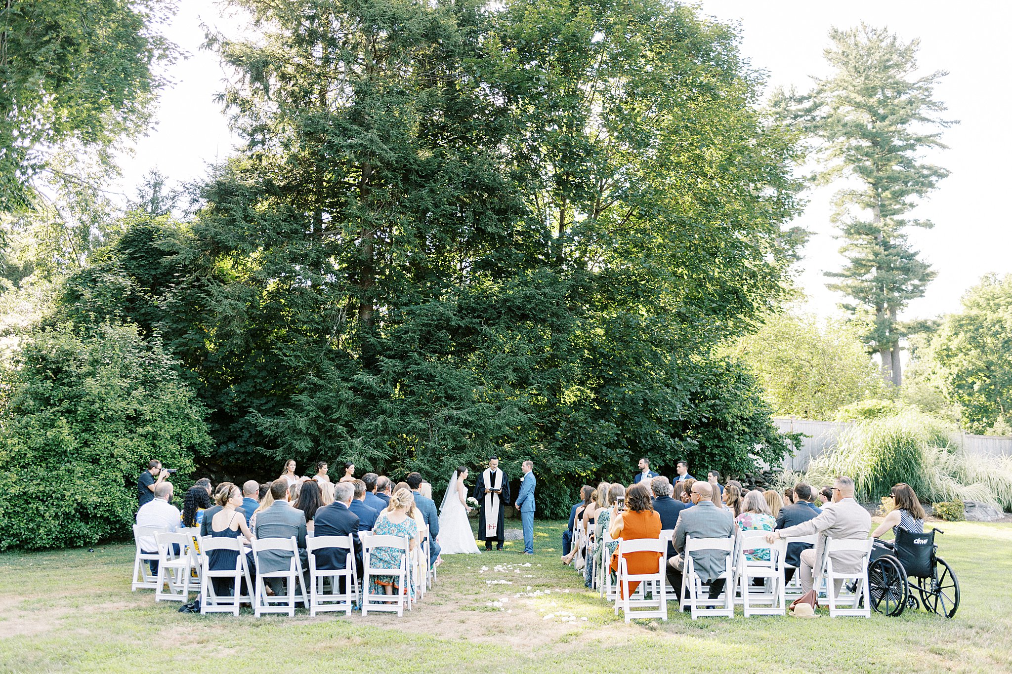 intimate ceremony held in front of trees at Field Club of Greenwich 