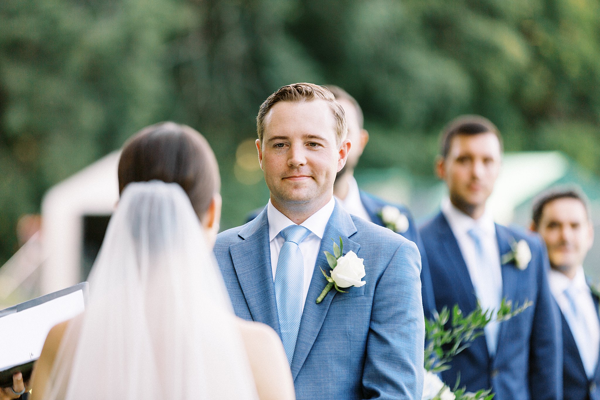 man smiles at his bride during ceremony by Cape Cod wedding photographer