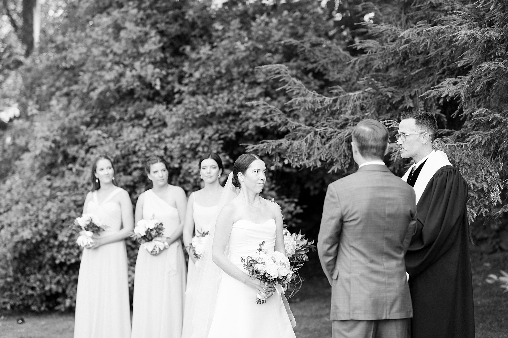 bride looks at officiant during ceremony at Field Club of Greenwich 