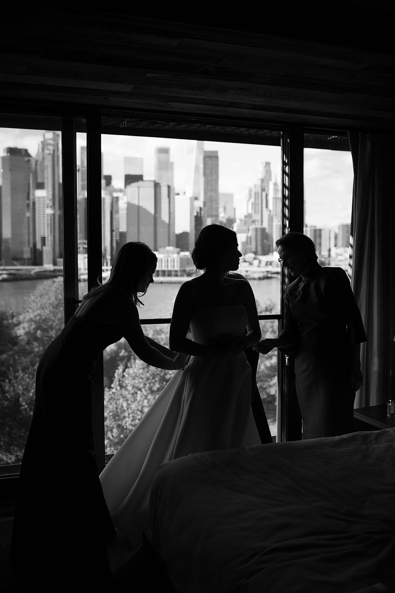 bride silhouetted with skyline behind by NYC wedding photographer 