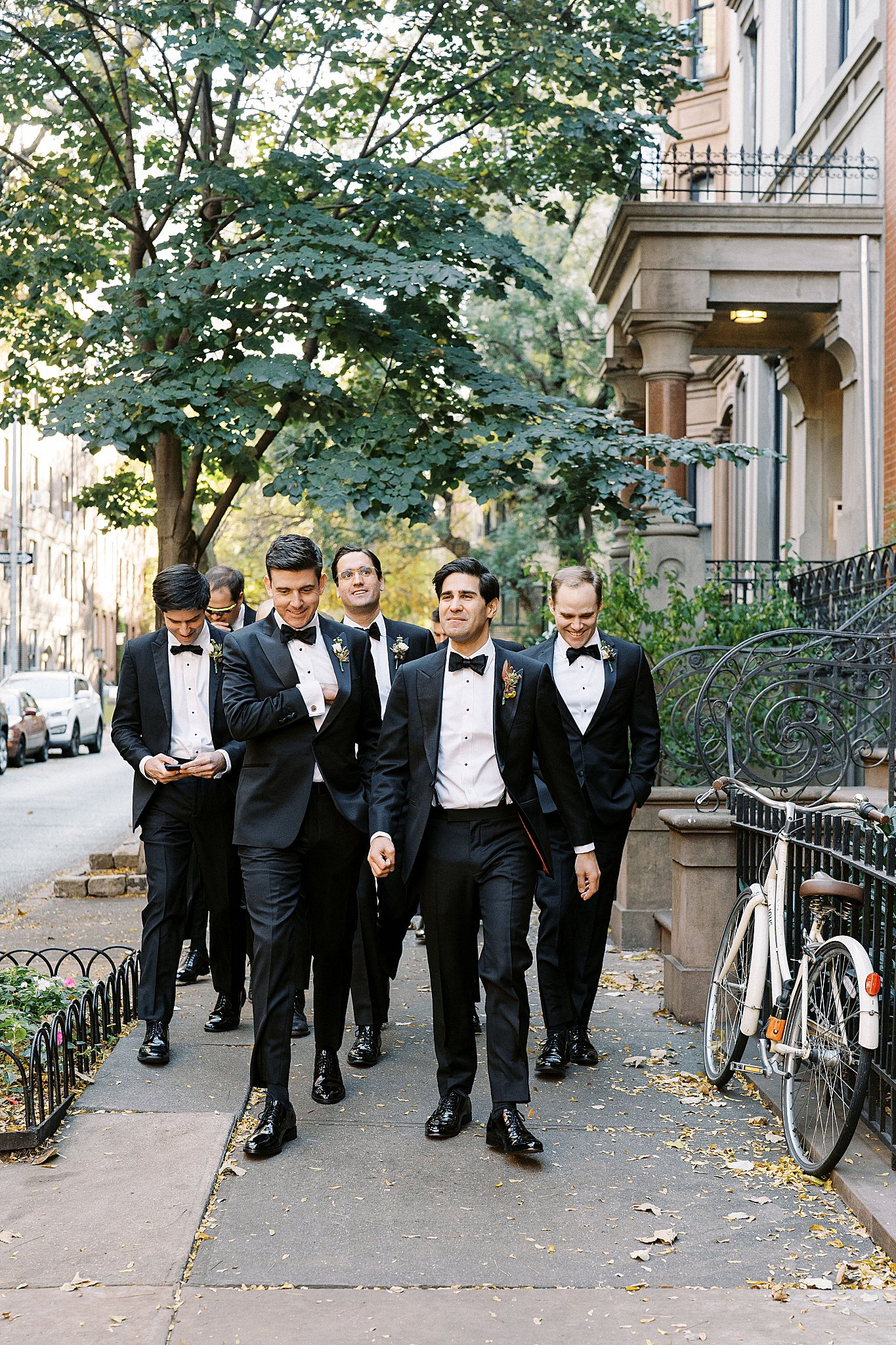 groomsmen walk down sidewalk toward Brooklyn Heights Casino