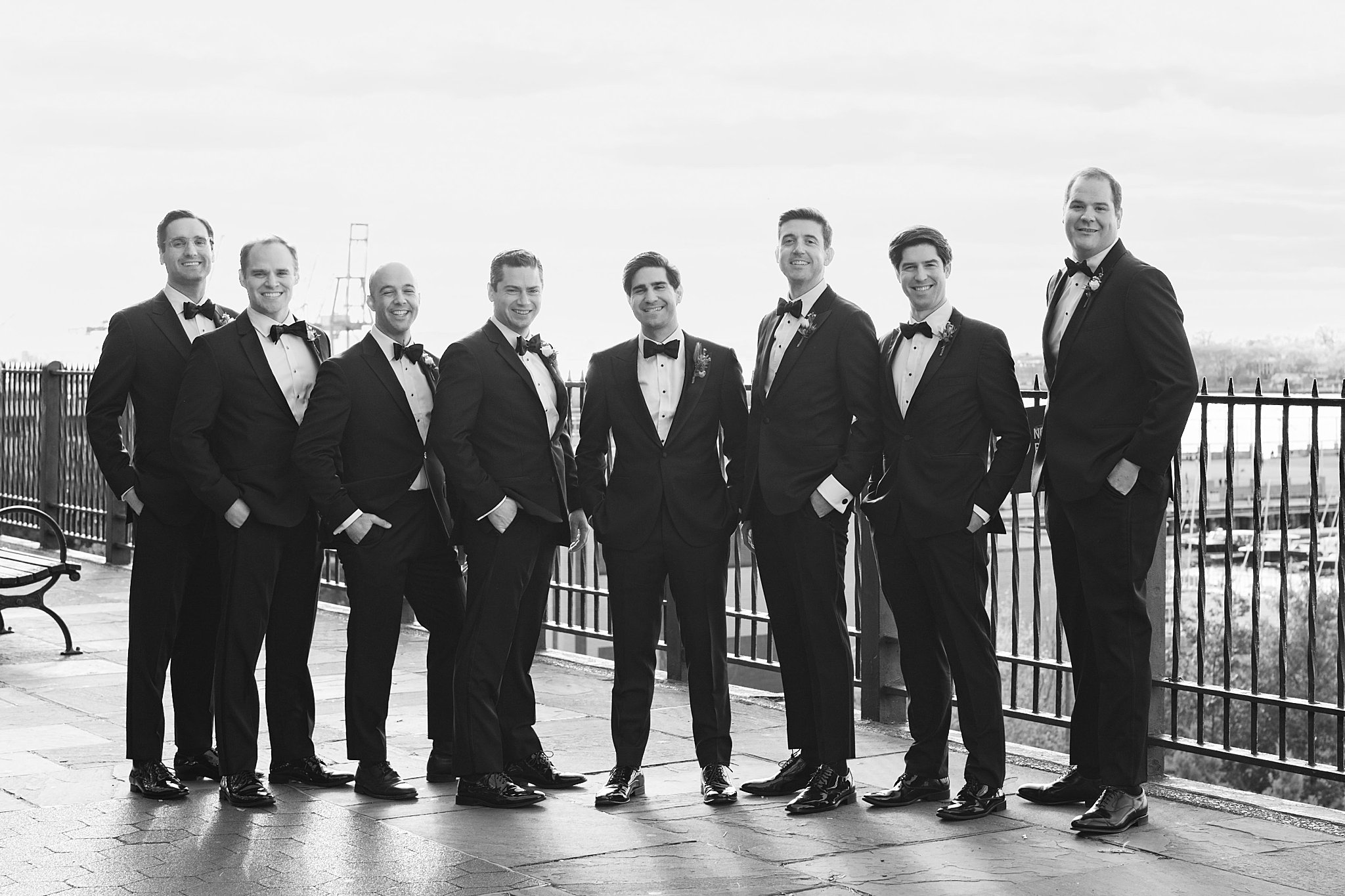 groomsmen smile with hands in pockets by Lynne Reznick Photography
