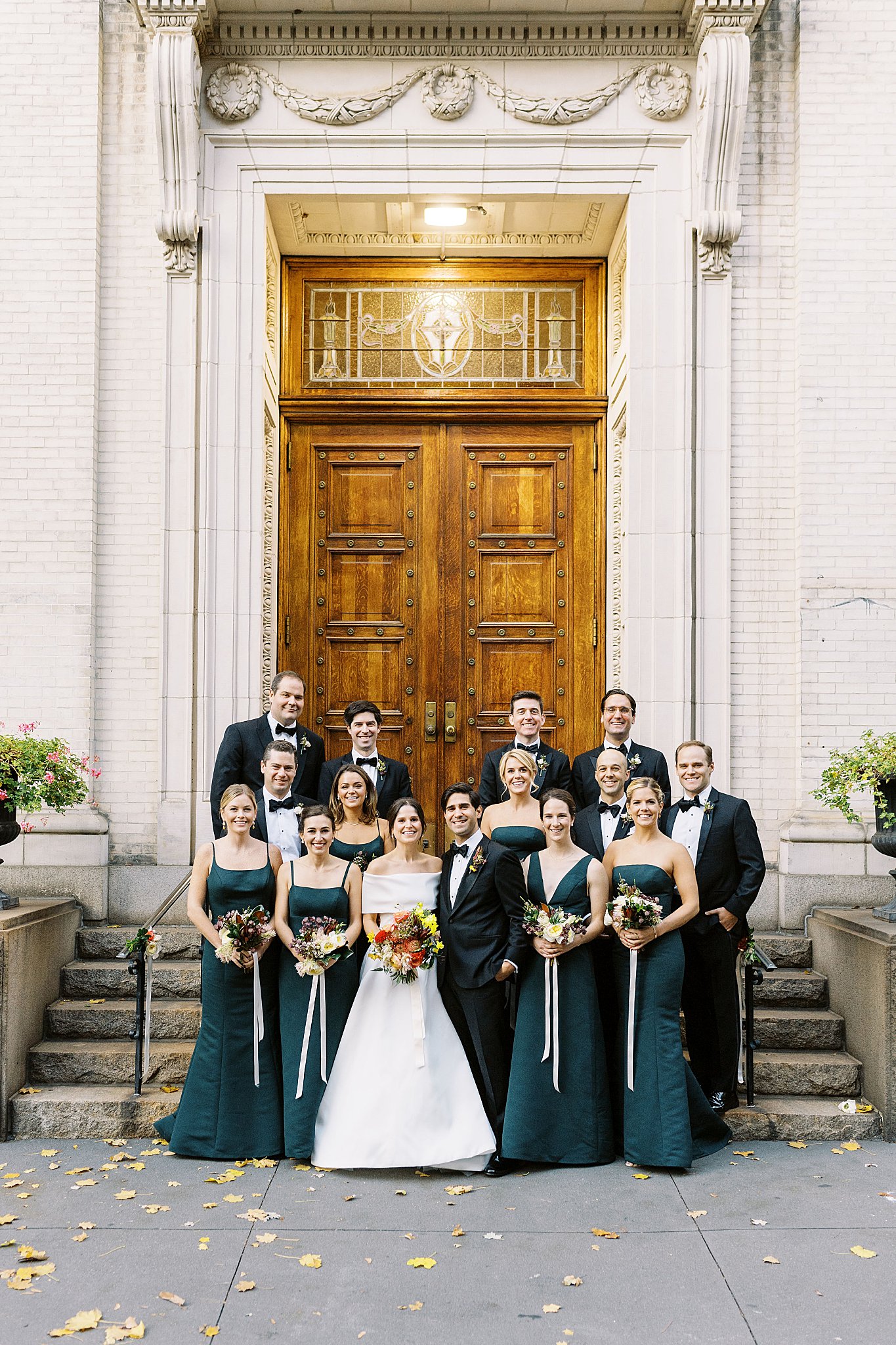 wedding party gathers on church steps by Lynne Reznick Photography